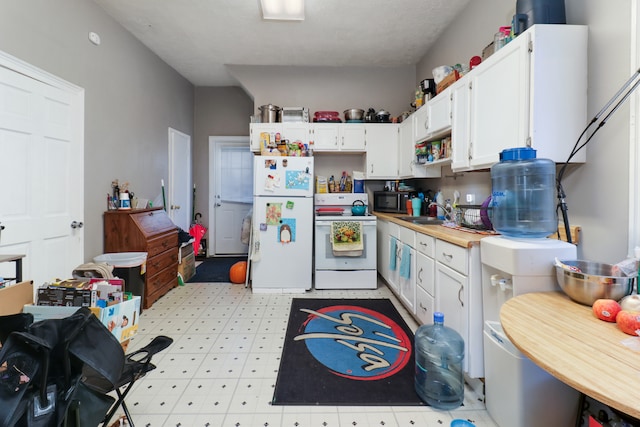 kitchen featuring white cabinets, white appliances, and sink