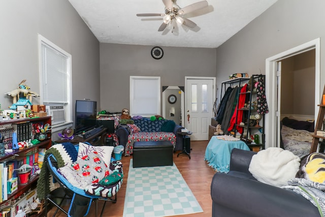 living room with cooling unit, hardwood / wood-style floors, and ceiling fan