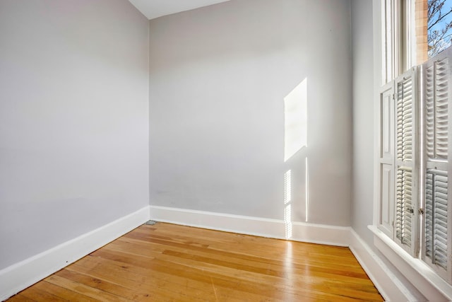 unfurnished room featuring hardwood / wood-style flooring