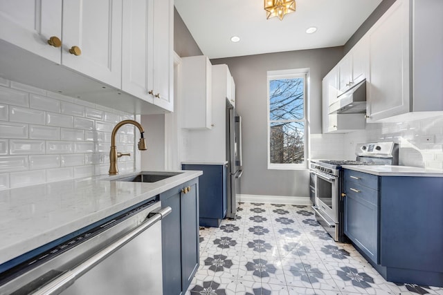 kitchen featuring appliances with stainless steel finishes, tasteful backsplash, blue cabinets, sink, and white cabinets