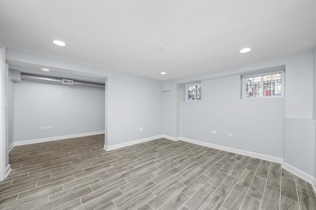 basement with light hardwood / wood-style flooring