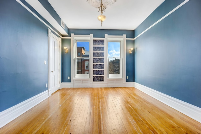 unfurnished room featuring hardwood / wood-style flooring