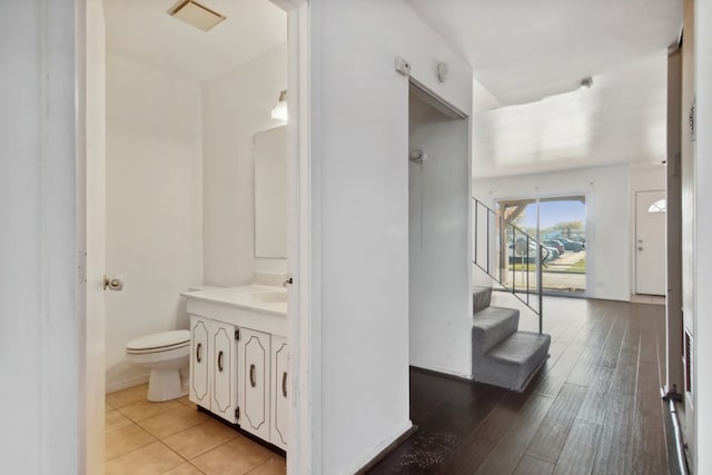 bathroom featuring hardwood / wood-style floors, vanity, and toilet