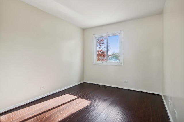 unfurnished room featuring dark hardwood / wood-style floors