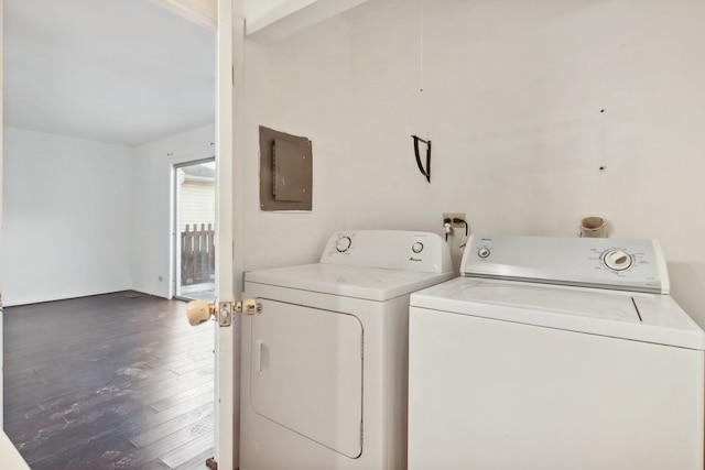 washroom featuring electric panel, separate washer and dryer, and dark hardwood / wood-style flooring