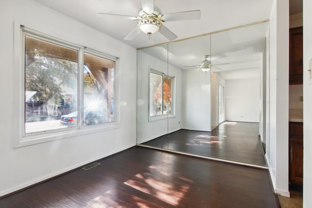 unfurnished room featuring dark hardwood / wood-style flooring and ceiling fan