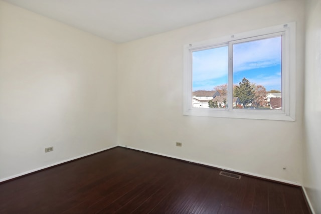 spare room with hardwood / wood-style floors