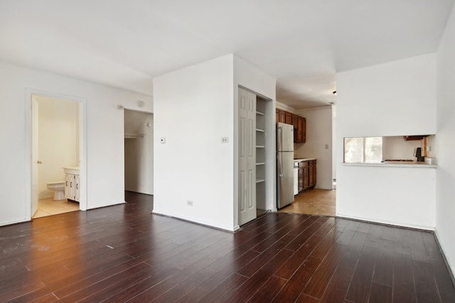 unfurnished living room with dark wood-type flooring