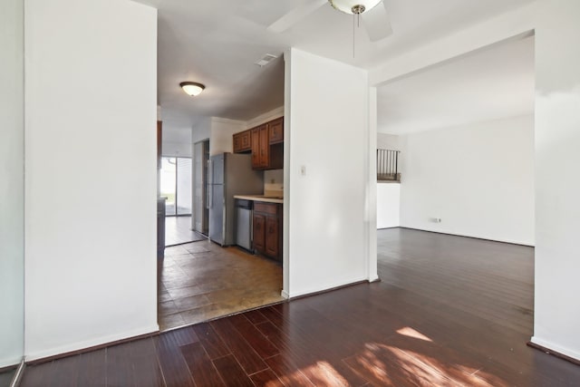 kitchen featuring stainless steel appliances, dark hardwood / wood-style flooring, and ceiling fan