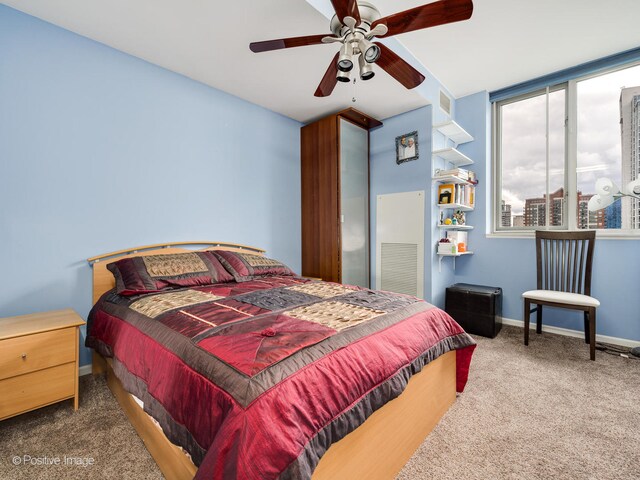 bedroom featuring dark carpet and ceiling fan