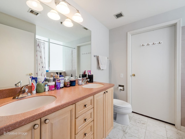 bathroom with walk in shower, vanity, and toilet