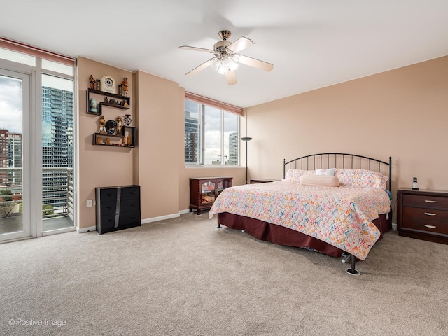 carpeted bedroom featuring access to outside and ceiling fan