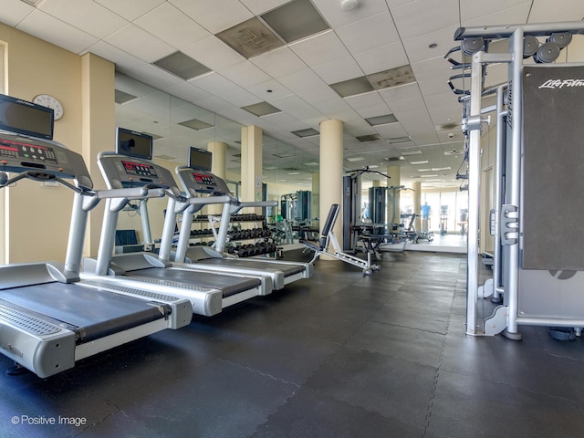 gym with a paneled ceiling