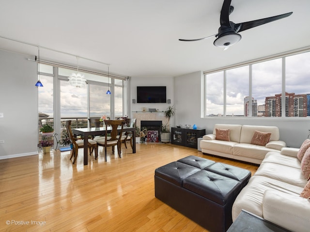 living room with wood-type flooring and ceiling fan