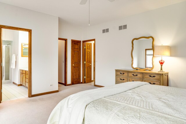 carpeted bedroom with ceiling fan and ensuite bathroom