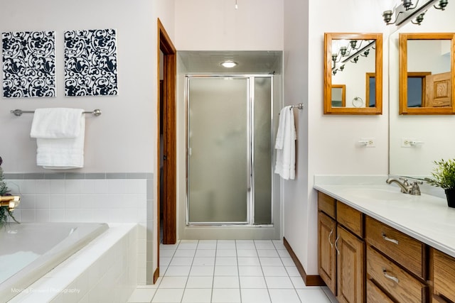 bathroom with tile patterned flooring, vanity, and separate shower and tub