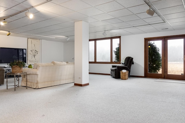 living room with rail lighting, carpet floors, and a drop ceiling