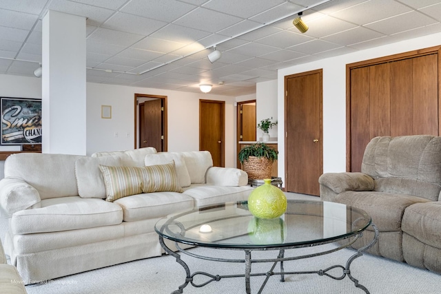 living room featuring a paneled ceiling