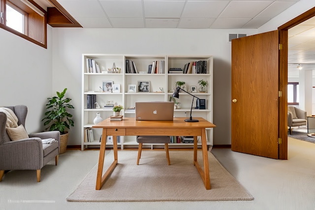 office space with a paneled ceiling