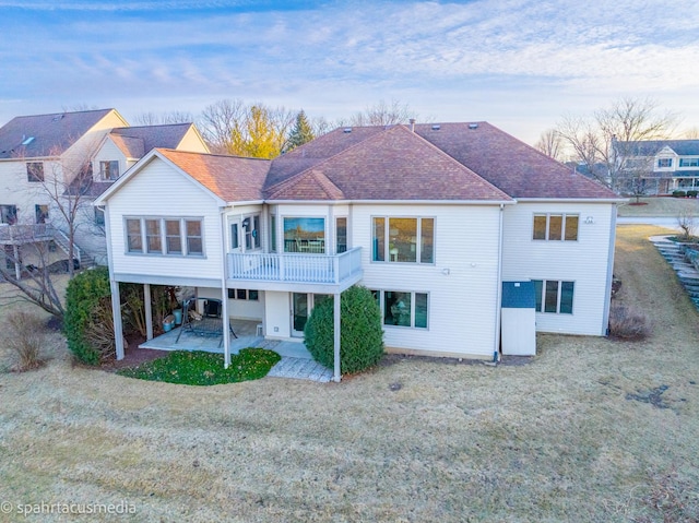 back of house with a yard, a patio area, and a deck