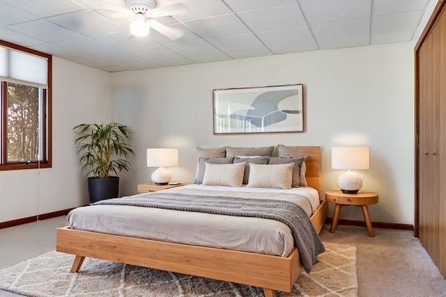 bedroom featuring carpet flooring, a closet, and a drop ceiling