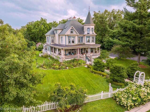 victorian-style house featuring a porch and a front yard