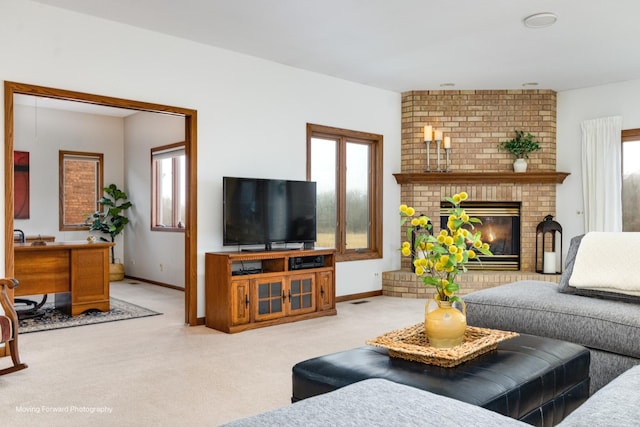 carpeted living room featuring a wealth of natural light and a fireplace