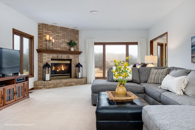 carpeted living room featuring a brick fireplace