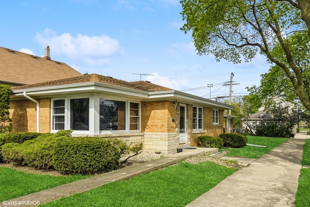 view of side of home with a lawn