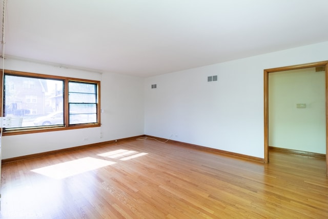 spare room with light hardwood / wood-style floors