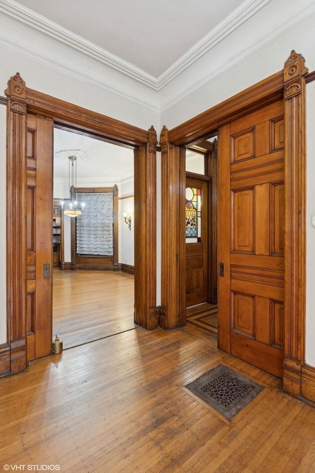 interior space with crown molding and wood-type flooring