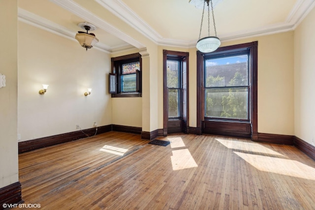 foyer entrance featuring crown molding and hardwood / wood-style floors