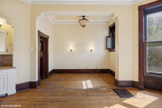 unfurnished room featuring wood-type flooring and ornamental molding