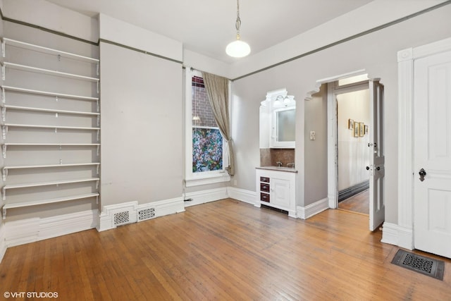 unfurnished living room with hardwood / wood-style flooring