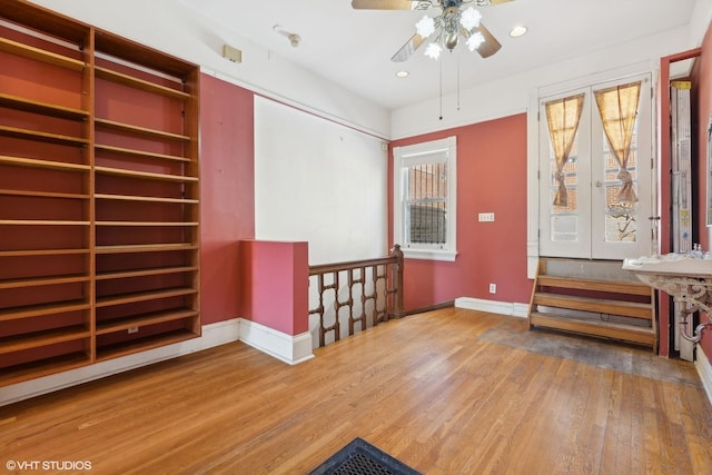 interior space with wood-type flooring and ceiling fan