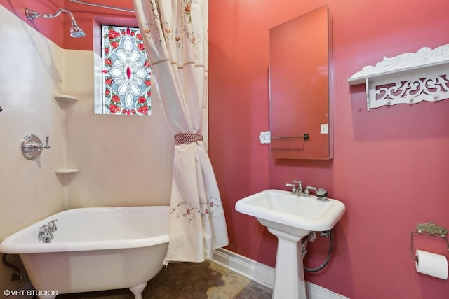 bathroom with sink and a tub to relax in