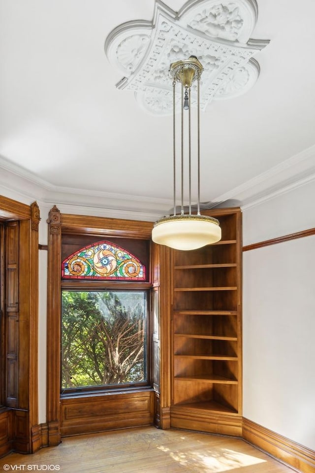 interior details featuring crown molding and hardwood / wood-style flooring