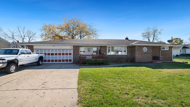 ranch-style home with a garage and a front lawn