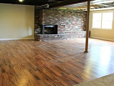 basement with wood-type flooring and a fireplace