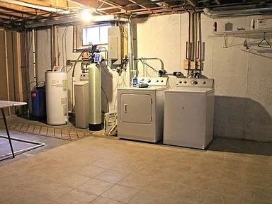 washroom with electric panel, water heater, and washer and clothes dryer