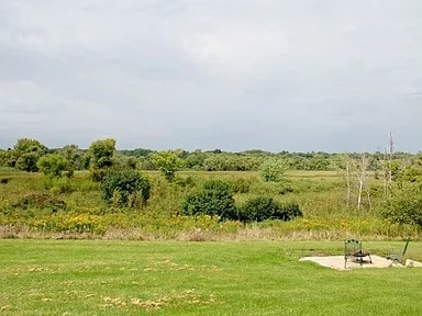 view of home's community with a lawn and a rural view