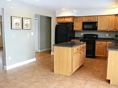 kitchen featuring black appliances and a kitchen island