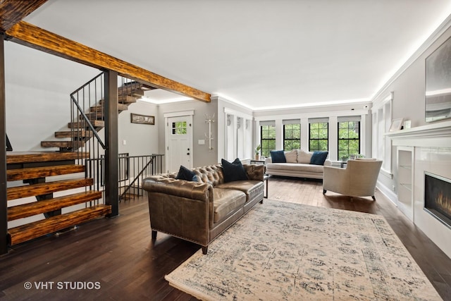 living room with dark wood-type flooring, crown molding, and beamed ceiling