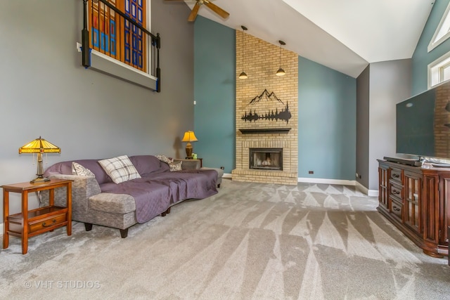 living room featuring a fireplace, light colored carpet, ceiling fan, and high vaulted ceiling