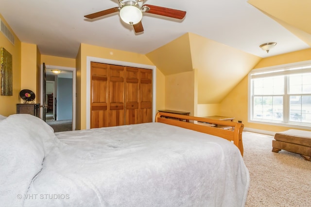 bedroom with ceiling fan, a closet, lofted ceiling, and carpet