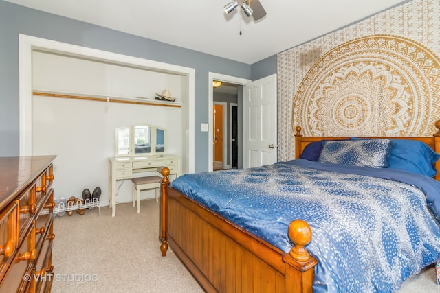 carpeted bedroom featuring a closet and ceiling fan