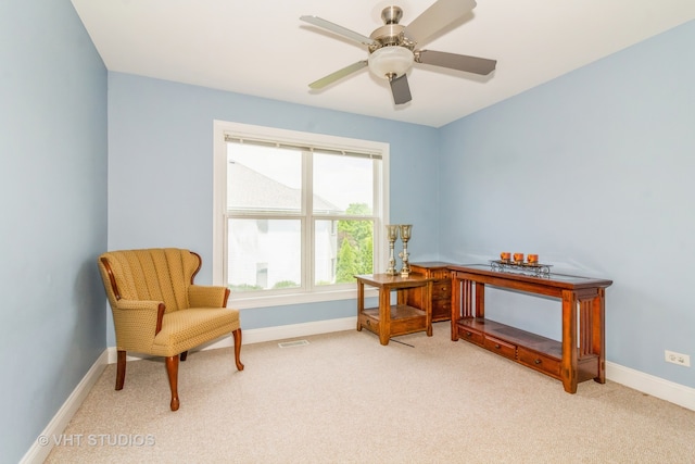 sitting room with light colored carpet and ceiling fan