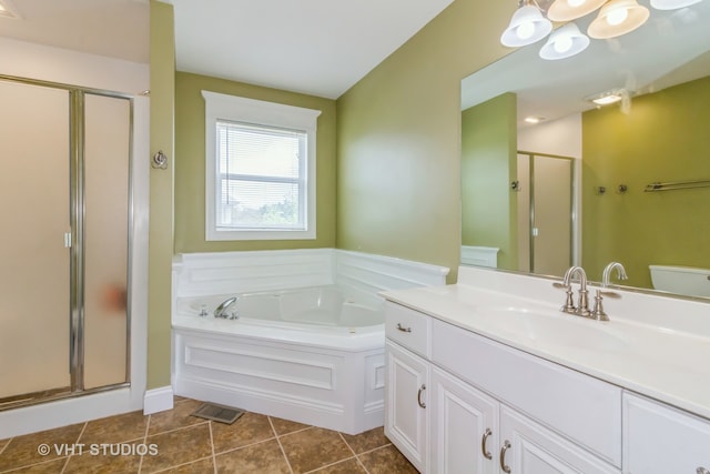 bathroom with tile patterned flooring, vanity, and separate shower and tub