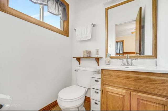 bathroom featuring toilet and vanity