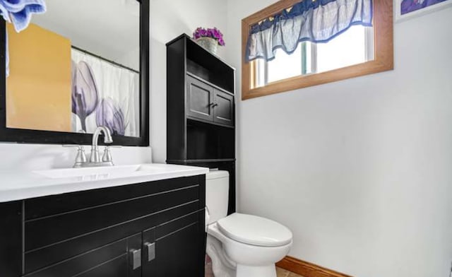 bathroom featuring toilet and vanity